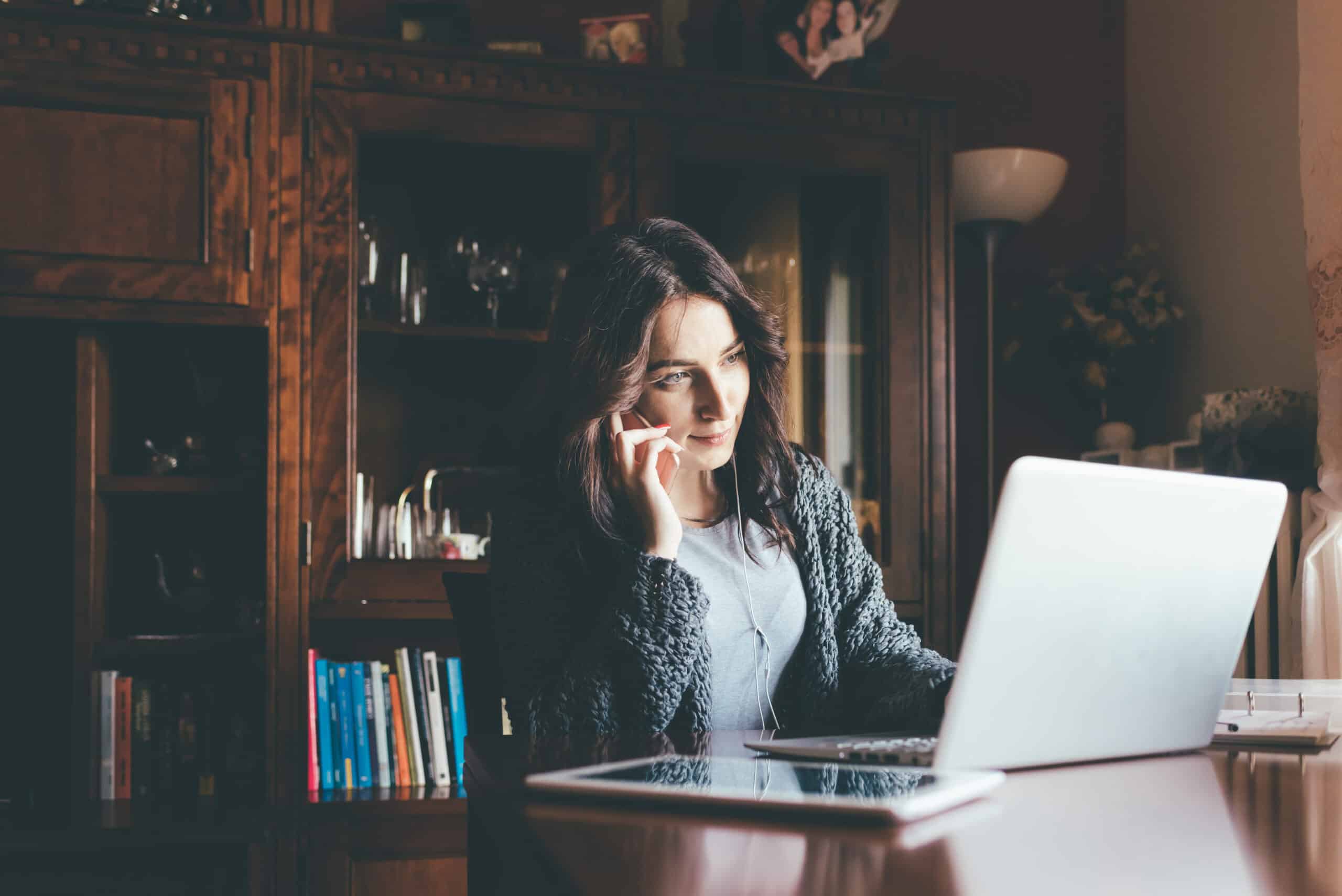 The Art Of Risk-Taking: How Entrepreneurs Thrive In Uncertainty 3 Graphicstock entrepreneur calling on phone and working on line with a laptop sitting in a desk at home business technology multitasking concept htwwete5yw scaled